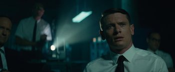 Movie still from “Seberg” (2019), directed by Benedict Andrews – A man wearing a suit and a tie; Close Up shot, Low angle