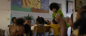 Movie still from “Seberg” (2019), directed by Benedict Andrews – A group of children sitting at a table with a teacher; Medium shot, Low angle