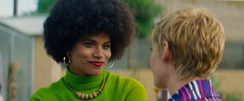 Movie still from “Seberg” (2019), directed by Benedict Andrews – A woman in a green shirt is talking to another woman; Close Up shot, Over the shoulder angle