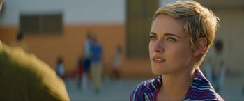 Movie still from “Seberg” (2019), directed by Benedict Andrews – A person wearing a colorful shirt; Close Up shot, Over the shoulder angle