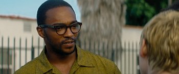 Movie still from “Seberg” (2019), directed by Benedict Andrews – A person wearing glasses; Close Up shot, Over the shoulder angle