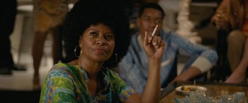 Movie still from “Seberg” (2019), directed by Benedict Andrews – An older woman holding a cigarette in her hand; Close Up shot, Over the shoulder angle