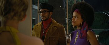 Movie still from “Seberg” (2019), directed by Benedict Andrews – A man and a woman standing next to each other; Medium shot, Low angle