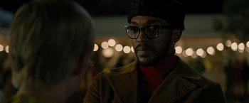 Movie still from “Seberg” (2019), directed by Benedict Andrews – A man wearing glasses and a hat is talking to a woman; Close Up shot, Over the shoulder angle