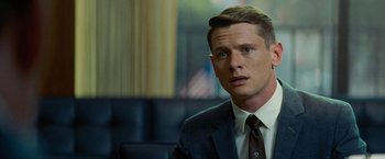 Movie still from “Seberg” (2019), directed by Benedict Andrews – A person wearing a suit and tie; Close Up shot, Over the shoulder angle