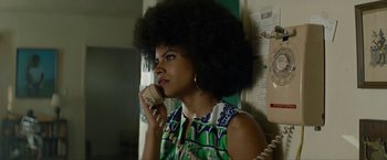 Movie still from “Seberg” (2019), directed by Benedict Andrews – A woman with afro talking on a phone; Close Up shot, Low angle