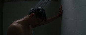Movie still from “Seberg” (2019), directed by Benedict Andrews – A young man is taking a shower in a bathroom; Close Up shot, Low angle
