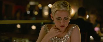 Movie still from “Seberg” (2019), directed by Benedict Andrews – A woman with short blonde hair wearing a silver dress; Close Up shot, Over the shoulder angle