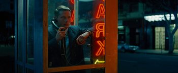 Movie still from “Seberg” (2019), directed by Benedict Andrews – A man in a suit is talking on a phone; Medium shot, Low angle