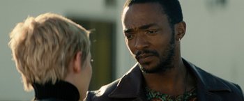 Movie still from “Seberg” (2019), directed by Benedict Andrews – A man in a leather jacket talking to another man; Close Up shot, Over the shoulder angle