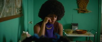 Movie still from “Seberg” (2019), directed by Benedict Andrews – A woman sitting in front of a mirror with her hand to her face; Medium shot, Over the shoulder angle