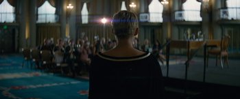 Movie still from “Seberg” (2019), directed by Benedict Andrews – A woman standing in front of an audience with her back turned; Medium shot, Low angle