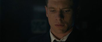 Movie still from “Seberg” (2019), directed by Benedict Andrews – A person wearing a suit and tie; Close Up shot, Low angle