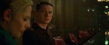 Movie still from “Seberg” (2019), directed by Benedict Andrews – A man sitting in front of a group of people; Close Up shot, Over the shoulder angle