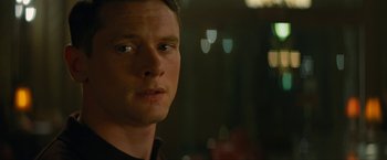 Movie still from “Seberg” (2019), directed by Benedict Andrews – A man's face in a dark room; Close Up shot, Over the shoulder angle