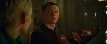 Movie still from “Seberg” (2019), directed by Benedict Andrews – A man in a brown shirt sitting in front of a table; Close Up shot, Over the shoulder angle