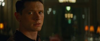 Movie still from “Seberg” (2019), directed by Benedict Andrews – A man's face in front of a window; Close Up shot, Over the shoulder angle