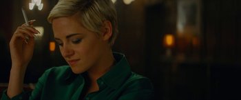 Movie still from “Seberg” (2019), directed by Benedict Andrews – A person wearing a green shirt; Close Up shot, Over the shoulder angle