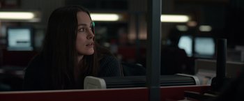 Movie still from “Official Secrets” (2019), directed by Gavin Hood – A woman sitting in a bus looking out the window; Close Up shot, Over the shoulder angle