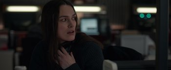 Movie still from “Official Secrets” (2019), directed by Gavin Hood – A beautiful young lady sitting in front of a computer monitor; Close Up shot, Over the shoulder angle