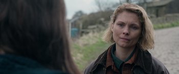 Movie still from “Official Secrets” (2019), directed by Gavin Hood – A woman standing next to another woman on a field; Close Up shot, Over the shoulder angle