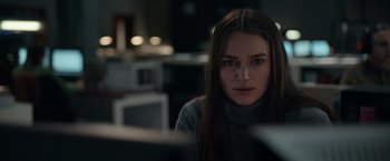 Movie still from “Official Secrets” (2019), directed by Gavin Hood – A woman in a grey sweater looking at the camera; Close Up shot, Over the shoulder angle