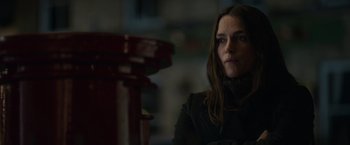 Movie still from “Official Secrets” (2019), directed by Gavin Hood – A woman in a black jacket is looking at the camera; Close Up shot, Low angle