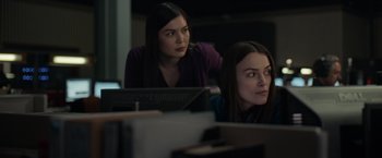 Movie still from “Official Secrets” (2019), directed by Gavin Hood – Two women sitting in front of a laptop computer; Medium shot, Over the shoulder angle