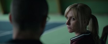 Movie still from “Official Secrets” (2019), directed by Gavin Hood – A woman looking at another woman in a green room; Close Up shot, Over the shoulder angle