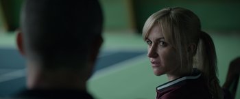 Movie still from “Official Secrets” (2019), directed by Gavin Hood – A woman is looking at a man in a green room; Close Up shot, Over the shoulder angle