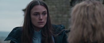 Movie still from “Official Secrets” (2019), directed by Gavin Hood – A woman sitting in front of a brick wall; Close Up shot, Over the shoulder angle