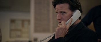 A man holding a phone up to his ear