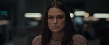 Movie still from “Official Secrets” (2019), directed by Gavin Hood – A person with long dark hair; Close Up shot, Over the shoulder angle