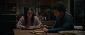 Movie still from “Official Secrets” (2019), directed by Gavin Hood – A man and a woman sitting at a table eating food; Medium shot, Over the shoulder angle