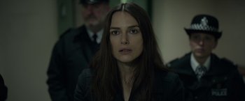 Movie still from “Official Secrets” (2019), directed by Gavin Hood – A person with long hair; Close Up shot, Over the shoulder angle