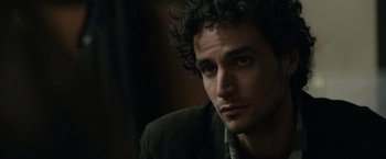 Movie still from “Official Secrets” (2019), directed by Gavin Hood – A person with curly hair; Close Up shot, Over the shoulder angle