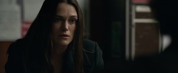 Movie still from “Official Secrets” (2019), directed by Gavin Hood – A person with long dark hair; Close Up shot, Over the shoulder angle