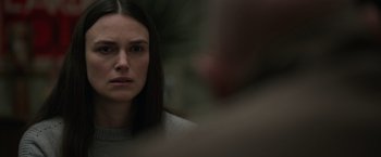 Movie still from “Official Secrets” (2019), directed by Gavin Hood – A person with long dark hair; Close Up shot, Over the shoulder angle