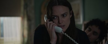 Movie still from “Official Secrets” (2019), directed by Gavin Hood – A woman holding a phone to her ear; Close Up shot, High angle