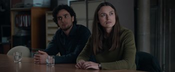 Movie still from “Official Secrets” (2019), directed by Gavin Hood – A man and a woman sitting next to each other at a table; Medium shot, Over the shoulder angle