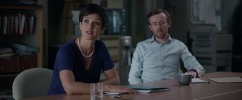Movie still from “Official Secrets” (2019), directed by Gavin Hood – A woman sitting at a table in front of a man; Medium shot, Over the shoulder angle