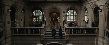 Movie still from “Official Secrets” (2019), directed by Gavin Hood – Two women are walking down the stairs of a building; Extreme Wide shot, High angle