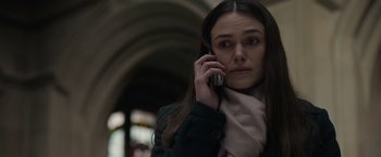 Movie still from “Official Secrets” (2019), directed by Gavin Hood – A woman is talking on a cell phone while wearing a scarf; Close Up shot, Low angle