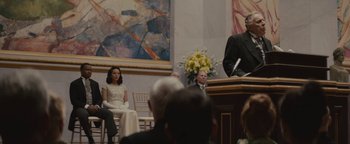 Movie still from “Selma” (2014), directed by Ava DuVernay – A man is speaking at an event in front of an audience; Medium shot, Over the shoulder angle