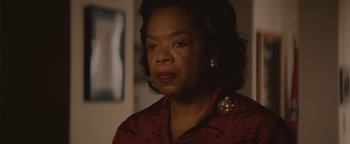 Movie still from “Selma” (2014), directed by Ava DuVernay – An older woman in a red shirt is looking to her left; Close Up shot, Over the shoulder angle