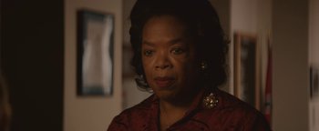 Movie still from “Selma” (2014), directed by Ava DuVernay – An older black woman in a red shirt looking at the camera; Close Up shot, Over the shoulder angle