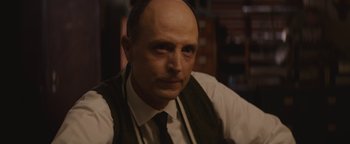 Movie still from “Selma” (2014), directed by Ava DuVernay – A bald man with a mustache wearing a vest and a tie; Close Up shot, Over the shoulder angle