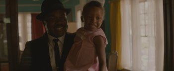 Movie still from “Selma” (2014), directed by Ava DuVernay – A man and a little girl smiling for the camera; Medium shot, High angle