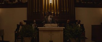 Movie still from “Selma” (2014), directed by Ava DuVernay – A man is speaking at a podium in front of a pipe organ; Medium shot, Low angle