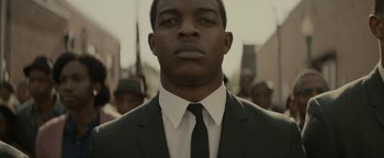 Movie still from “Selma” (2014), directed by Ava DuVernay – A man wearing a suit and tie standing in front of a crowd; Close Up shot, Low angle
